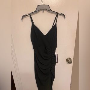 Brand new Black dress with slit on the side size Medium